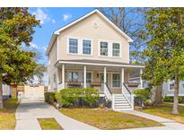 Charming two-story home with manicured landscaping and a welcoming front porch on a sunny day at 1322 Addykay Pl, North Charleston, SC 29406
