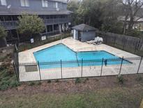 Community swimming pool with lounge chairs offers a refreshing escape at 1530 Fort Johnson Rd # 3F, Charleston, SC 29412
