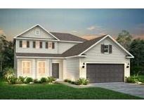 Charming two-story home with a symmetrical facade, well-manicured lawn, and a two-car garage at 163 Royal Cainhoy Way, Huger, SC 29450