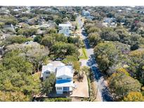 Aerial view showcases the neighborhood and the charming two-story home with a light metal roof at 18 Wills Way, Isle of Palms, SC 29451