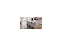 Island kitchen with white cabinets and hardwood floors at 351 Blue Oak Dr, Moncks Corner, SC 29461