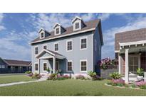 Charming blue two-story home with a covered porch and well-manicured front yard and lovely flowers at 719 Blueway Ave, Summerville, SC 29486