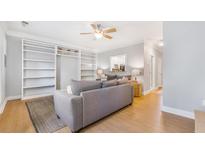 Bright living room boasts hardwood floors, ceiling fan, and custom built-in shelving for storage and decor at 947 E Estates Blvd # C, Charleston, SC 29414