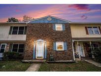 Charming townhome featuring a brick facade and a well-lit front entrance, perfect for a cozy neighborhood feel at 102 Brush Blvd, Goose Creek, SC 29445