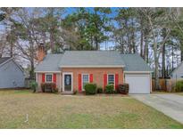 Charming brick home with red shutters, well-manicured lawn, and attached garage at 103 York Pl, Goose Creek, SC 29445