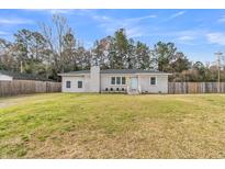 Charming single-story home featuring a well-manicured lawn, painted brick, and a classic design at 105 Gourdin St, Saint Stephen, SC 29479