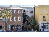Charming multi-story buildings with inviting storefronts and mature landscaping at 182 E Bay St # 303, Charleston, SC 29401