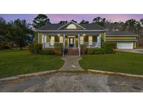 Charming home with a covered front porch, manicured lawn, and inviting entrance with stairs at 2101 Heavens Way, Summerville, SC 29483