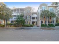 Well maintained condo building with manicured landscaping and assigned parking at 2212 Telfair Way, Charleston, SC 29412