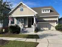 Charming single-Gathering home with a welcoming front porch and well-manicured landscaping at 3668 Maidstone Dr, Mount Pleasant, SC 29466