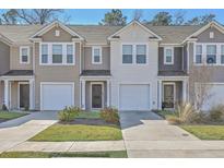 Charming townhomes with garages and well-maintained lawns offer curb appeal and convenient parking at 4678 Palm View Cir, North Charleston, SC 29418