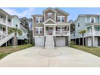 Charming elevated home featuring a spacious driveway and eye-catching red shutters at 524 Amalie Farms Dr, Charleston, SC 29492