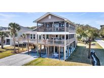 Charming elevated beach house featuring multiple decks, screened porch, and ground-level outdoor space at 601 Pompano Rd, Edisto Island, SC 29438