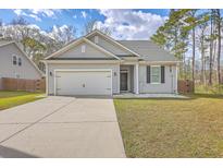 Charming single-story home with gray siding, manicured lawn, and attached two-car garage at 94 Dean Dr, Summerville, SC 29483