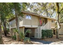 Charming two-story home with beautiful mature trees, front stairs, and covered parking at 1121 Summer Wind Ln, Seabrook Island, SC 29455