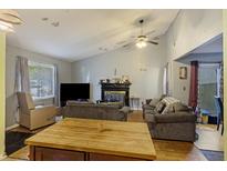 Inviting living room with a fireplace, neutral paint, comfortable seating, and natural light at 114 Tennyson Way, Summerville, SC 29486
