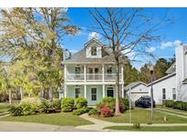 Charming two-story home featuring a double porch and lush landscaping at 1300 Carol Oaks Dr, Mount Pleasant, SC 29466
