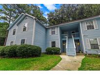 Charming two-story condo with light blue siding, white trim and shutters, and a well-maintained front lawn at 2011 Coldspring Dr # B, North Charleston, SC 29406
