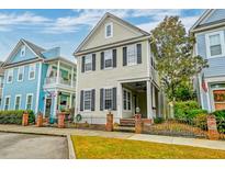 Charming two-story home with inviting front porch and manicured landscaping and an adjacent building at 312 White Gables Dr, Summerville, SC 29483