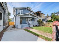 Charming two-story home with brick walkway, fresh lawn and inviting covered front porch at 35 Cypress St, Charleston, SC 29403