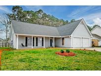 Charming single-story home featuring a well-manicured lawn, a two-car garage, and a welcoming front porch at 408 Trailway Dr, Summerville, SC 29486
