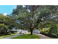 Inviting home exterior featuring a large shade tree overhanging the property at 426 Riverland Dr # A&B, Charleston, SC 29412