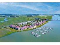Beautiful waterfront condos with boat docks along the coast, stunning aerial view at 5 W Mariners Cay Dr, Folly Beach, SC 29439