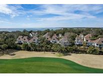 Scenic aerial view of elegant homes near a golf course, backing onto ocean, offering serene coastal living at 747 Spinnaker Beachhouse, Seabrook Island, SC 29455