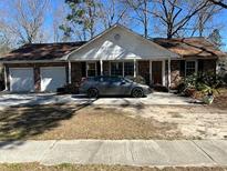 Charming single-story brick home featuring a two-car garage and a traditional gable roof at 8004 Malden Ave, North Charleston, SC 29420