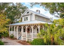 Charming two-story home featuring a spacious wrap-around porch, perfect for relaxation at 94 Seaside Cottage Ln, Isle of Palms, SC 29451