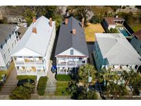 Aerial view of charming homes with inviting double porches and well-maintained landscaping in a desirable neighborhood at 318 Sumter St, Charleston, SC 29403