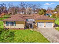Charming one-story home featuring a manicured lawn and an attached two-car garage at 1117 Walleye Rd, Bonneau, SC 29431