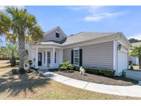 Charming single-story home with manicured landscaping, palm trees, and inviting entrance at 209 Sea Lavender Ln, Summerville, SC 29486