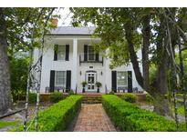 Stunning two-story home with brick path, manicured hedges, and lush green landscaping at 219 Rigby St, Reevesville, SC 29471