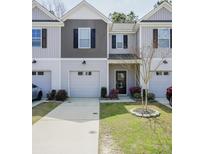 Charming townhome featuring a one-car garage, manicured lawn, and welcoming curb appeal at 232 Buchanan Cir, Goose Creek, SC 29445