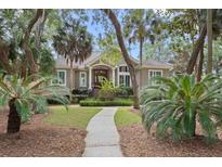 Charming single-Gathering home featuring a well-manicured lawn and welcoming front porch at 2515 Cat Tail Pond Rd, Seabrook Island, SC 29455