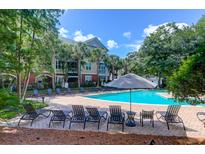 Enjoy this pristine pool with lounge chairs and beautiful landscaping at 300 Bucksley Ln # 104, Charleston, SC 29492