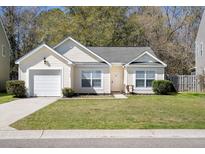 Charming one-story home with manicured lawn, attached garage, and inviting entrance at 5024 Blair Rd, Summerville, SC 29483