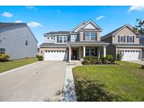 Charming two-story home with a well-manicured lawn and a two-car garage in a desirable neighborhood at 707 Redbud Ln, Summerville, SC 29486