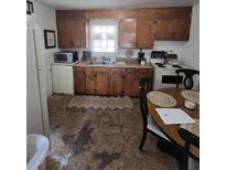 Features wooden cabinets and an eat-in table, offering a cozy space for casual dining at 824 Orangeburg Rd, Summerville, SC 29483