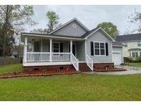 Charming single-Gathering home with a inviting covered front porch and well-manicured lawn at 8309 Berringer Bluff, North Charleston, SC 29418