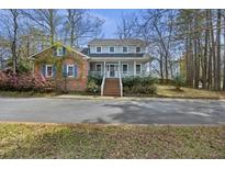 Charming two-story home with a brick accent, blue shutters, and a welcoming front porch at 100 Lakeview Dr, Summerville, SC 29485