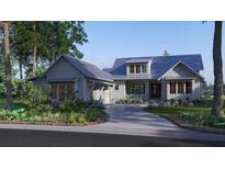 Charming gray craftsman home with metal roof, covered porch, and a curved driveway at 111 Peninsula Dr, Ravenel, SC 29470