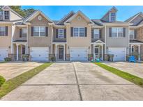 Row of townhomes featuring individual driveways and attached garages at 118 Lamplighter Ln, Summerville, SC 29486