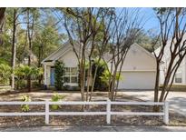 Charming home with a well-manicured front yard and a white picket fence at 1595 Harborsun Dr, Charleston, SC 29412