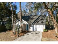 Charming single-story home with a two-car garage, long driveway, and a basketball hoop at 1728 Barracuda Rd, Johns Island, SC 29455