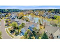 Stunning aerial view of a waterfront home with lush landscaping and a serene lake backdrop at 1896 Palmetto Isle Dr, Mount Pleasant, SC 29466