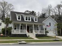 Charming home featuring a inviting front porch and well-maintained landscaping at 2415 Jasper Patterson Dr, Johns Island, SC 29455
