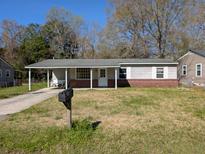 Cozy one-story home with a covered front porch and a well-maintained yard at 2508 Violet Ave, North Charleston, SC 29405