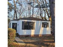 Charming single-story home featuring a well-maintained yard, black shutters and a welcoming front door at 2671 Houston St, North Charleston, SC 29405